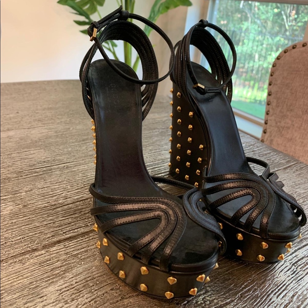 Black Gucci pumps with golden studs